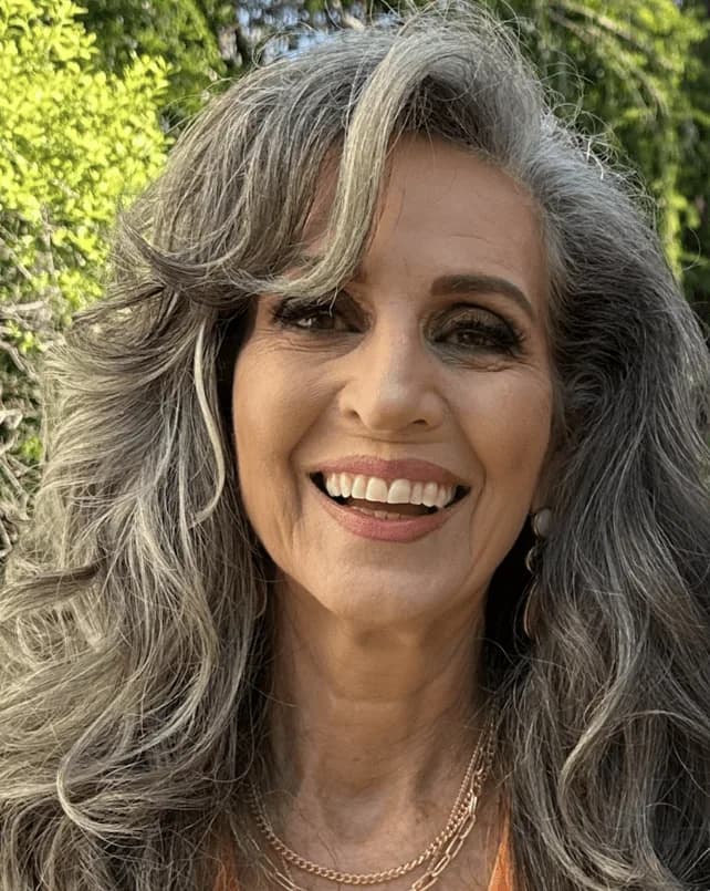 Gloria, silver-haired woman from Miami, Florida, sharing her going-gray story