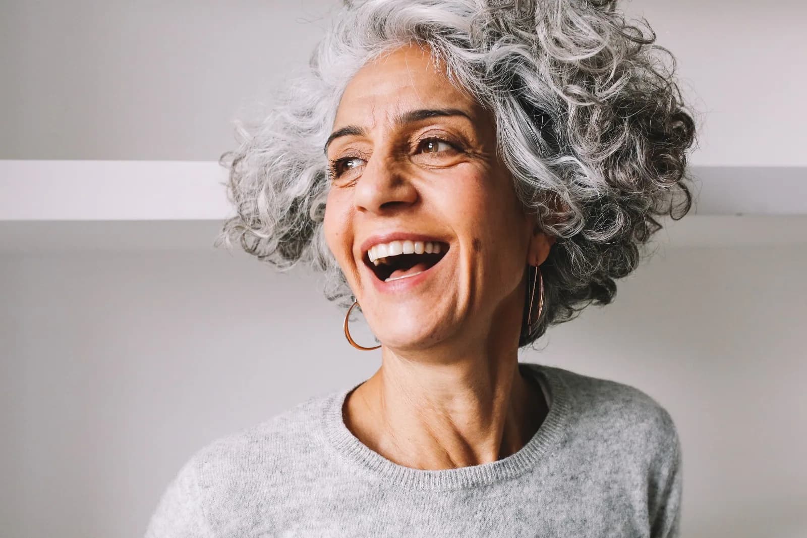 Silvina, silver-haired woman from London, UK, sharing her going-gray story