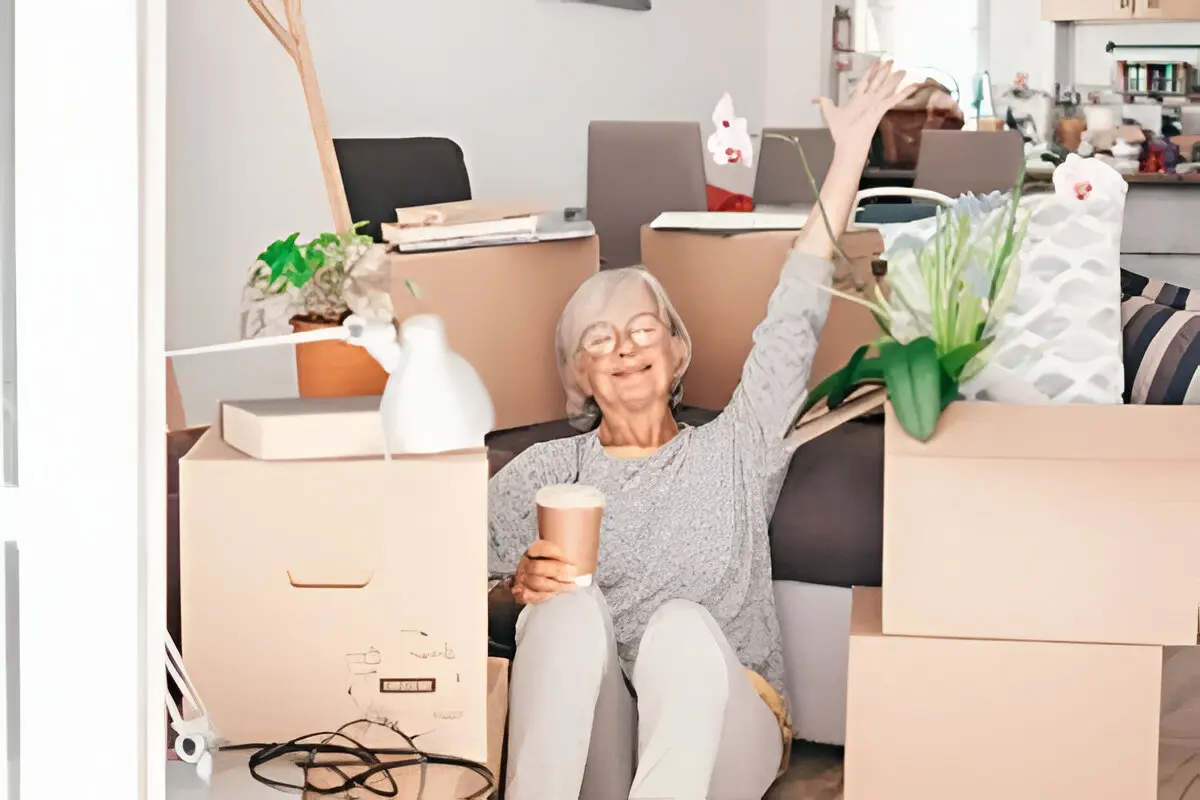 Happy woman during home move with plants