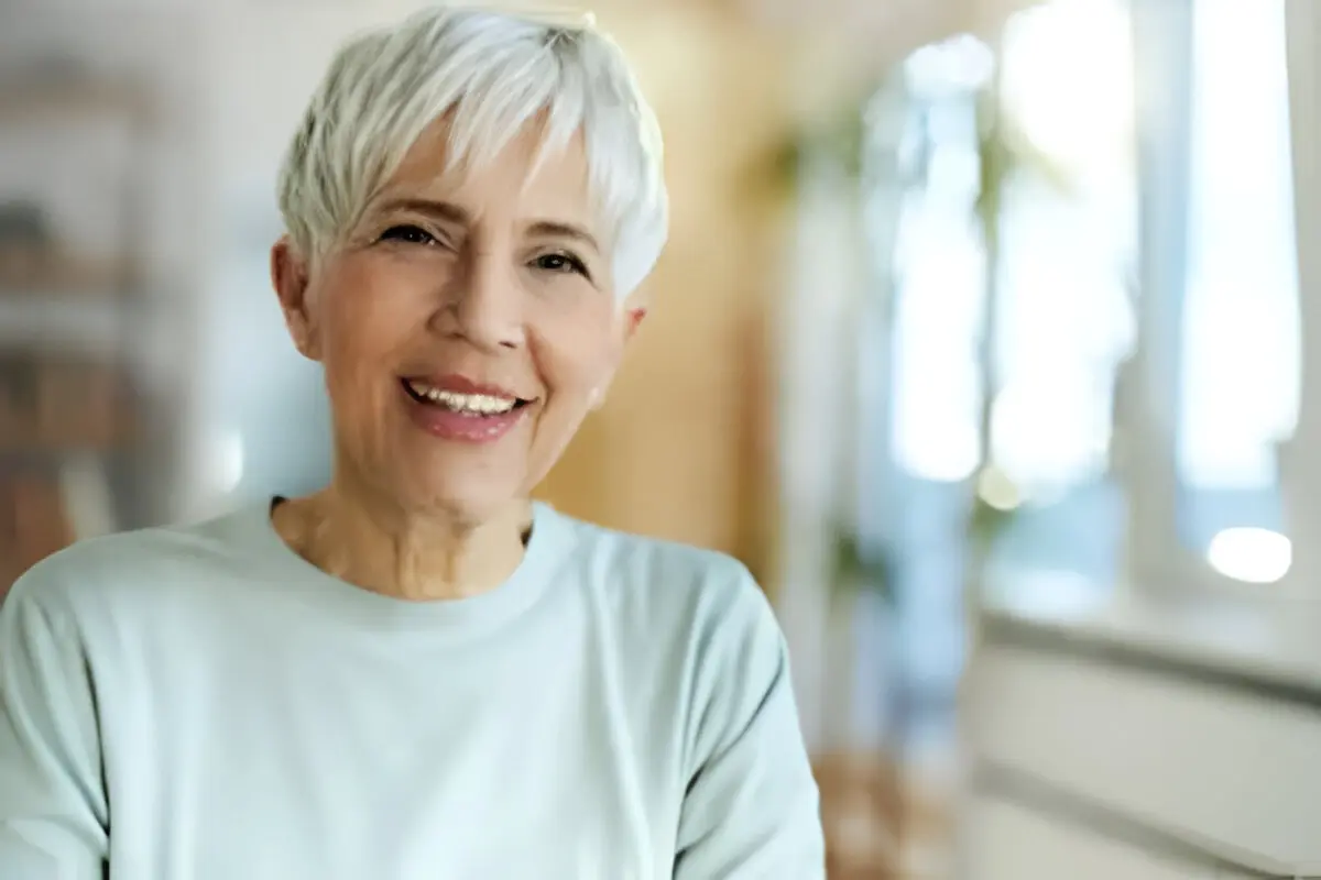 Smiling woman with short white hair